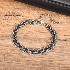 Detail of vintage double-layer stainless steel curb and rope chain bracelet for men
