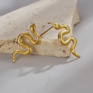 Vintage gold snake earrings in titanium steel with detailed scales on stone display
