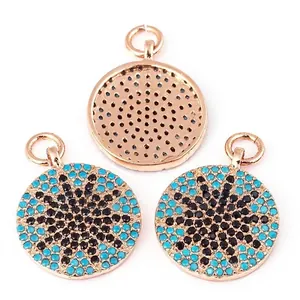 Three rose gold plated round pendants with turquoise and black pavé stone patterns