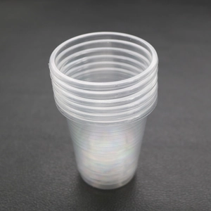 Stack of transparent plastic mixing cups for DIY epoxy resin and craft handmade tools