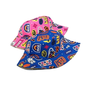 Close-up of graffiti print reversible kids bucket hats in pink and blue cotton fabric