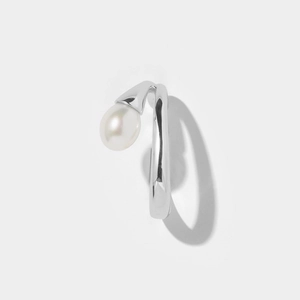 Detailed macro shot of a silver finish brass ear cuff with a white pearl accent