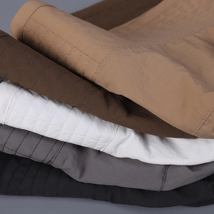 Stack of wide-brim sun hats showing multiple colors and detailed stitched textures
