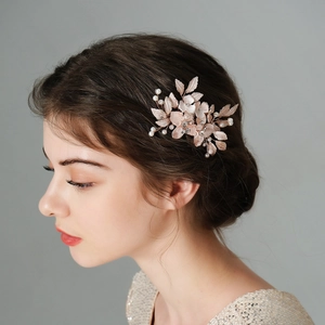 Rose gold bridal hair comb with pearls and rhinestones on elegant updo hairstyle