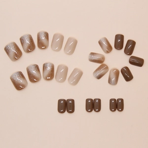Macro view of short square brown cat-eye nails with silver glitter and glossy finish