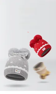 Close-up of knit texture on girls' winter hat with pompoms and decorative bows