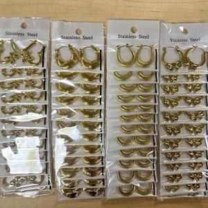 Detail of assorted hammered stainless steel gold earrings in wholesale packaging bags