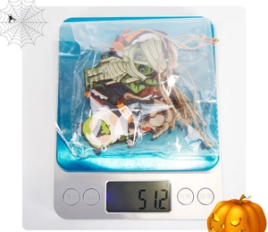 Halloween wooden ghost and dwarf ornaments weighed on a scale for set verification