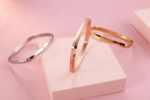 Detailed view of polished gold silver and rose gold geometric square titanium steel bangles