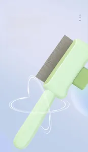 Detail of fine stainless steel teeth and non-slip handle on the pet grooming brush