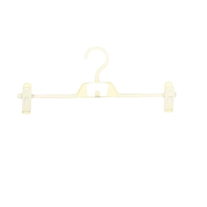 Space-saving cream-colored plastic pants hanger with adjustable clips for closet storage