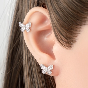 Silver butterfly ear studs and cuff set with sparkling zircons on model ear