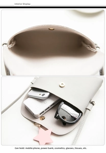 Detail view of grey PU crossbody bag showing internal space and star pendant accessory