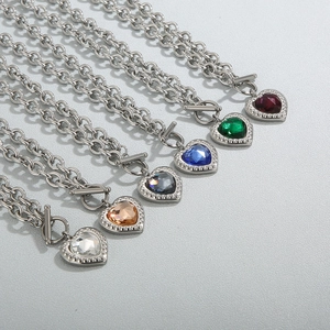 Detail of silver OT buckle necklaces with colorful heart crystal pendants in various shades