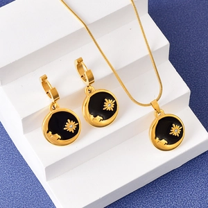 Golden sun and moon necklace and earrings set with black enamel and zircons