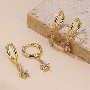 Boucles d'oreilles créoles dorées avec pendentifs fleurs en diamant sur socle de pierre