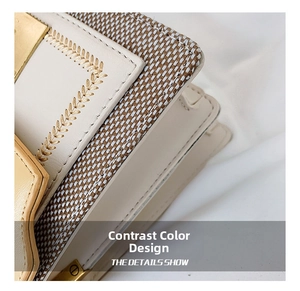 Detail showing the contrast color woven texture with gold embroidery on this crossbody bag