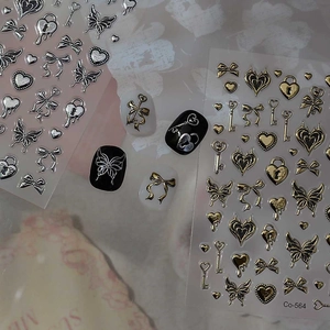 Detailed view of 3D gold and silver moon star nail stickers with gothic butterfly motifs