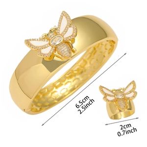Gold bee jewelry set with wide crystal bangle and open ring featuring white enamel wings