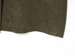 Detail shot of high-quality brown faux suede fabric with precise stitching on coat edges