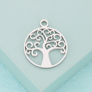 Silver tree of life hollow pendant made of stainless steel on a blue background