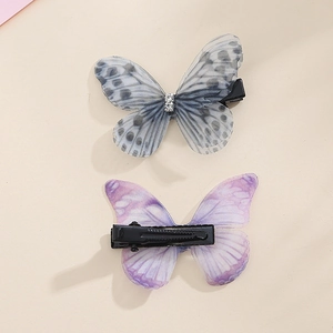 Close-up of double-layered tulle butterfly hair clips with sparkling crystal centers