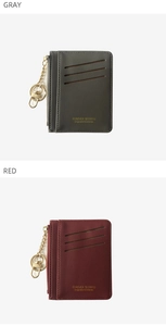 Detail view of leather card holder with card slots, zipper pouch and key ring in gray and red