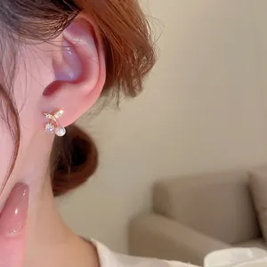 Asymmetric cherry earrings with cubic zirconia and pearls on elegant gold plating