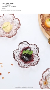Macro shot of cherry blossom glass dipping sauce dish with gold rim and pink petals