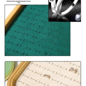 Detail of bamboo jewelry tray featuring dark green velvet slots for rings and studs