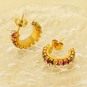 18K gold plated C-shaped hoop earrings with colorful crystals on a glass tray