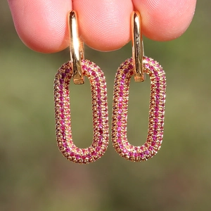 Detail of 18K gold plated hoop earrings with micro-pave pink cubic zirconia gems