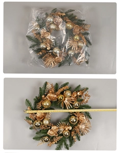 Detailed view of a green Christmas wreath with golden balls measured by a tape measure