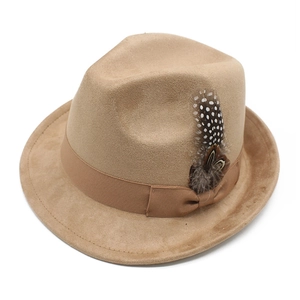Close-up of suede fedora hat with elegant ribbon bow and spotted natural feather detail
