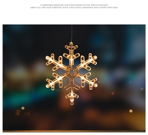 Close-up of warm white LED snowflake hanging light with festive bokeh background