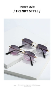 Detail view of frameless oval sunglasses with gradient lenses and gold metal nose bridge