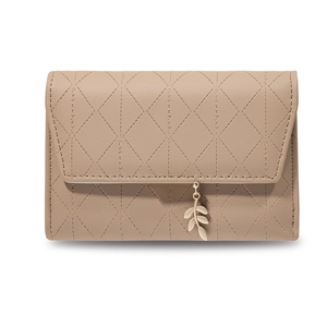 Detail of light brown PU leather wallet with diamond quilting and gold leaf pendant