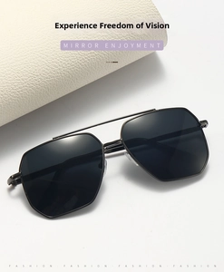 Detail shot of black aviator sunglasses with a double-bridge metal frame and dark lenses