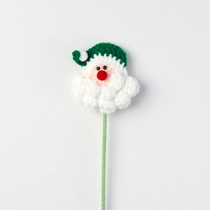 Detailed view of hand-knitted Santa Claus head ornament with green hat and white beard