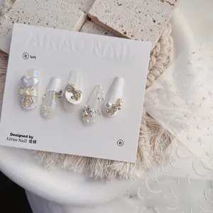 Detailed view of 5D embossed nail stickers featuring pearls, bows, and sparkling stars