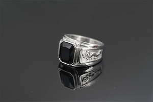 Macro shot of silver dragon ring featuring a large black octagonal cut gemstone
