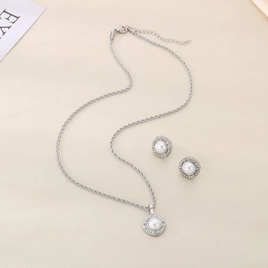 Silver stainless steel jewelry set with round pearl pendants and sparkling crystal accents