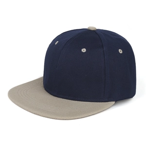 Detail of navy and grey flat brim baseball cap showing twill cotton texture and stitching