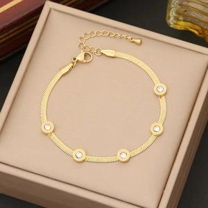 Gold braided snake chain bracelet with five round white zircons in a beige display box