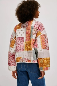 Back view of a boho quilted patchwork jacket with vintage floral patterns and drop shoulders