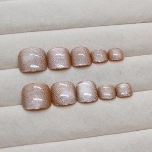 Champagne cat-eye press-on toenails with golden shimmer and magnetic pearl finish