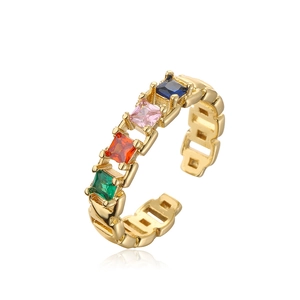 Macro detail of gold-plated open ring featuring four square-cut colorful zircons