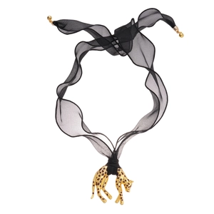 Golden leopard pendant with black spots and red eyes on a sheer black mesh ribbon necklace
