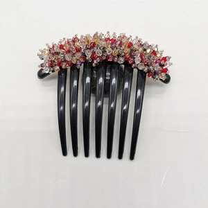 Detail view of handmade multi-color crystal bead flower comb with seven black resin teeth