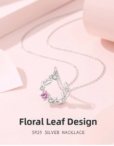 Close-up of S925 silver necklace with floral wreath pendant and pink gemstone